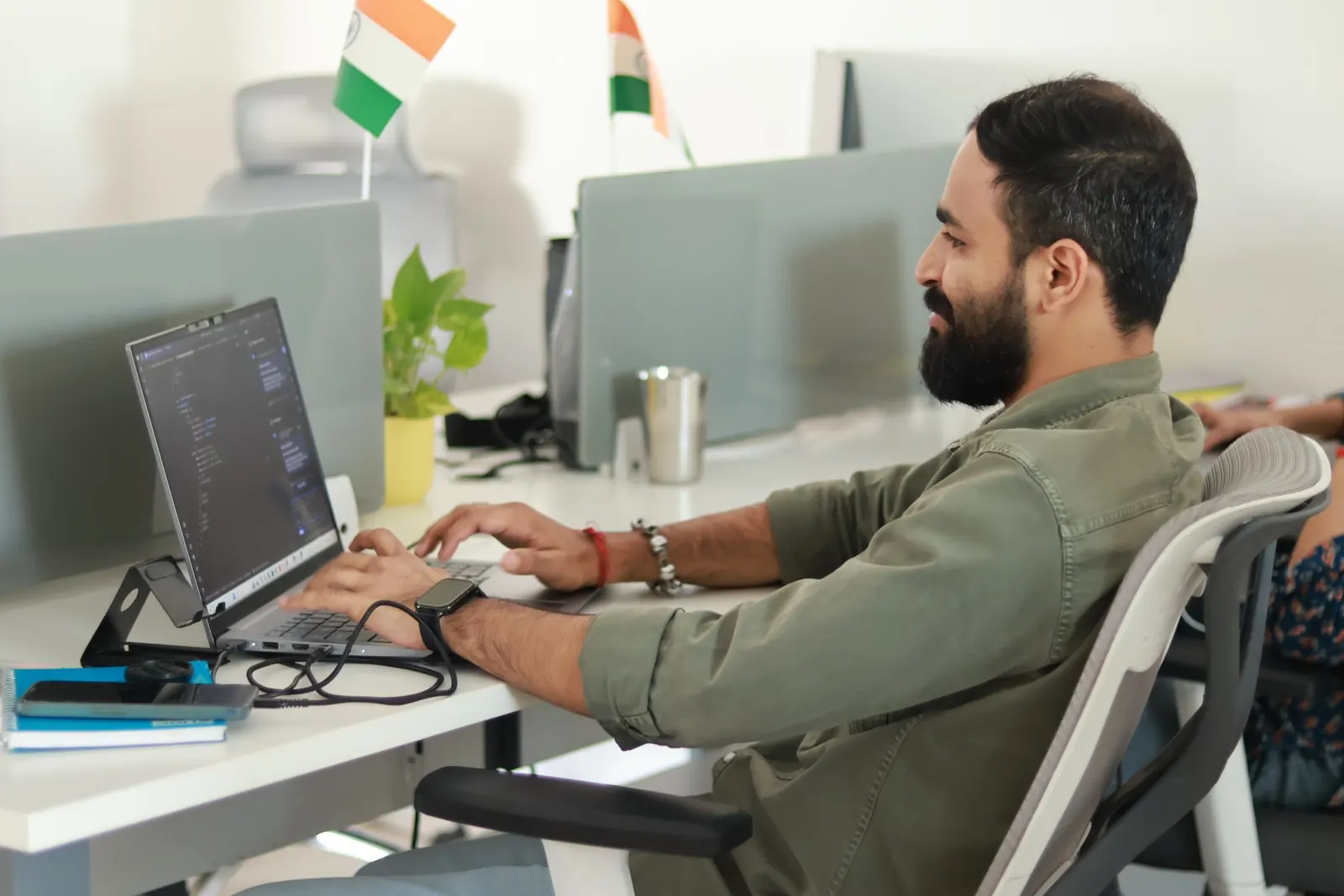 An engineer working at a laptop at his desk